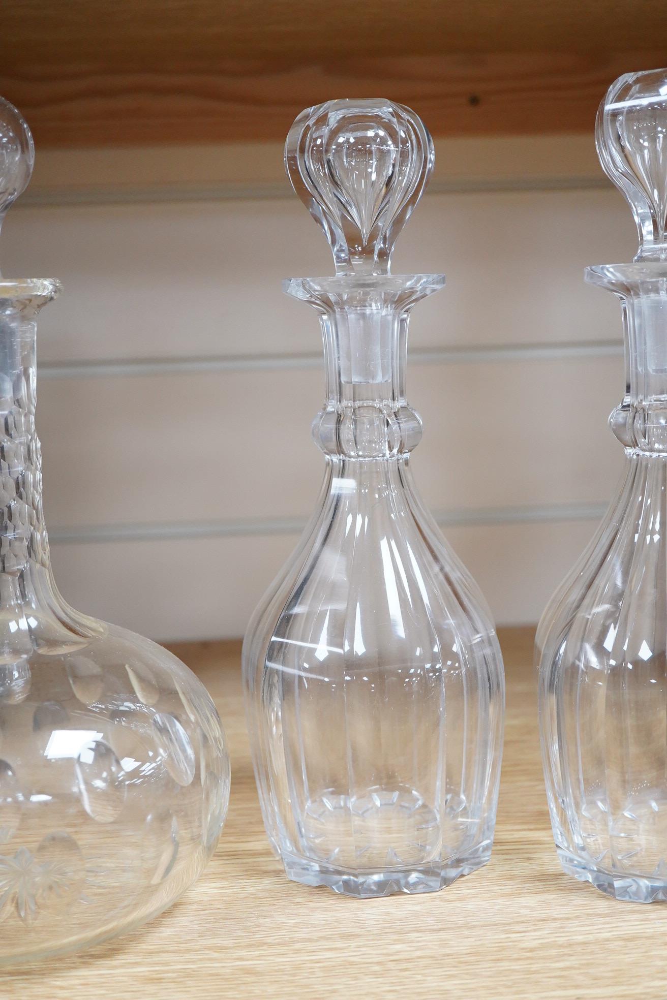 A pair small cut glass decanters and stoppers - 27cm high and a larger similar single decanter and stopper